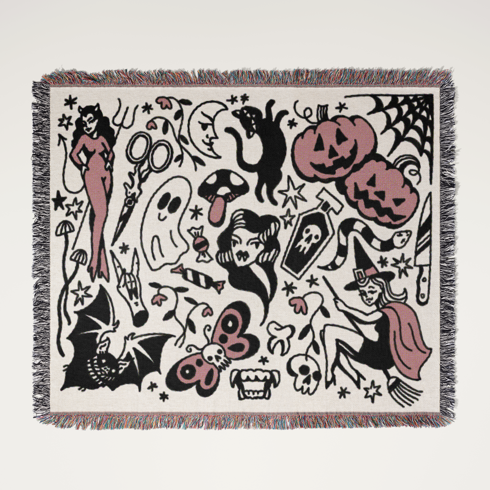 Woven blanket with Halloween-themed design featuring ghosts, pumpkins, and witches on a white background.