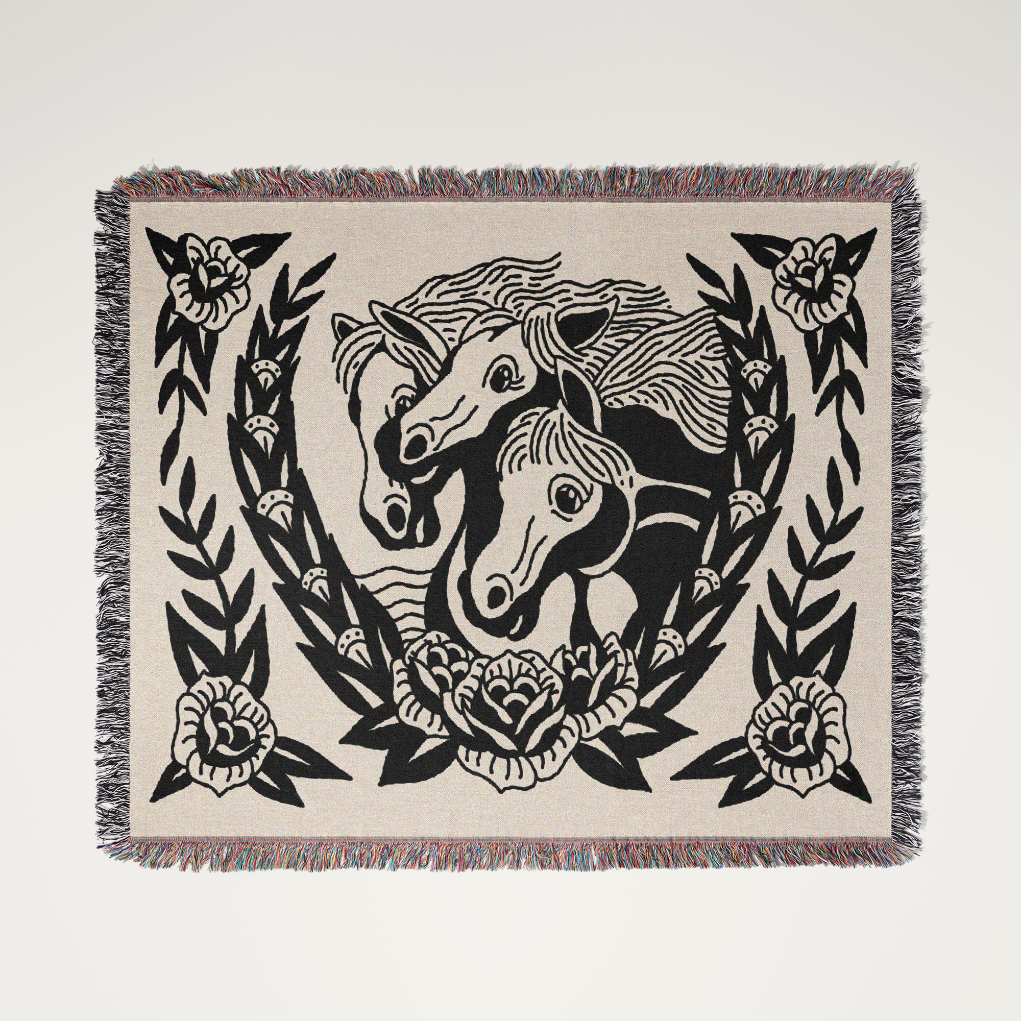 Woven blanket with black horse design on a beige background