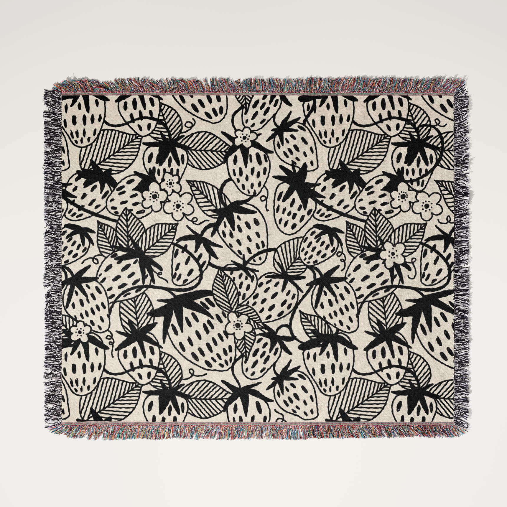 Woven blanket with black and white pattern on a light gray background